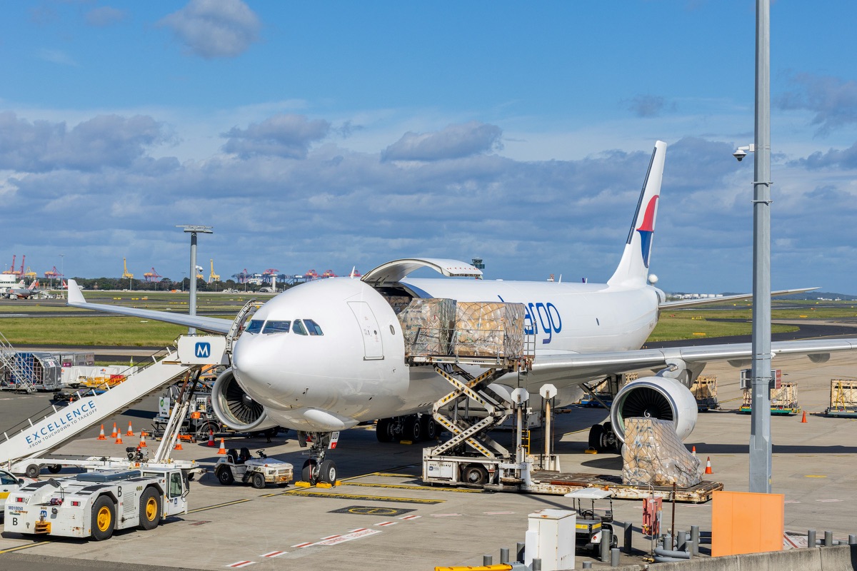 Pallets being loaded into a cargo aircraft on an airport apron