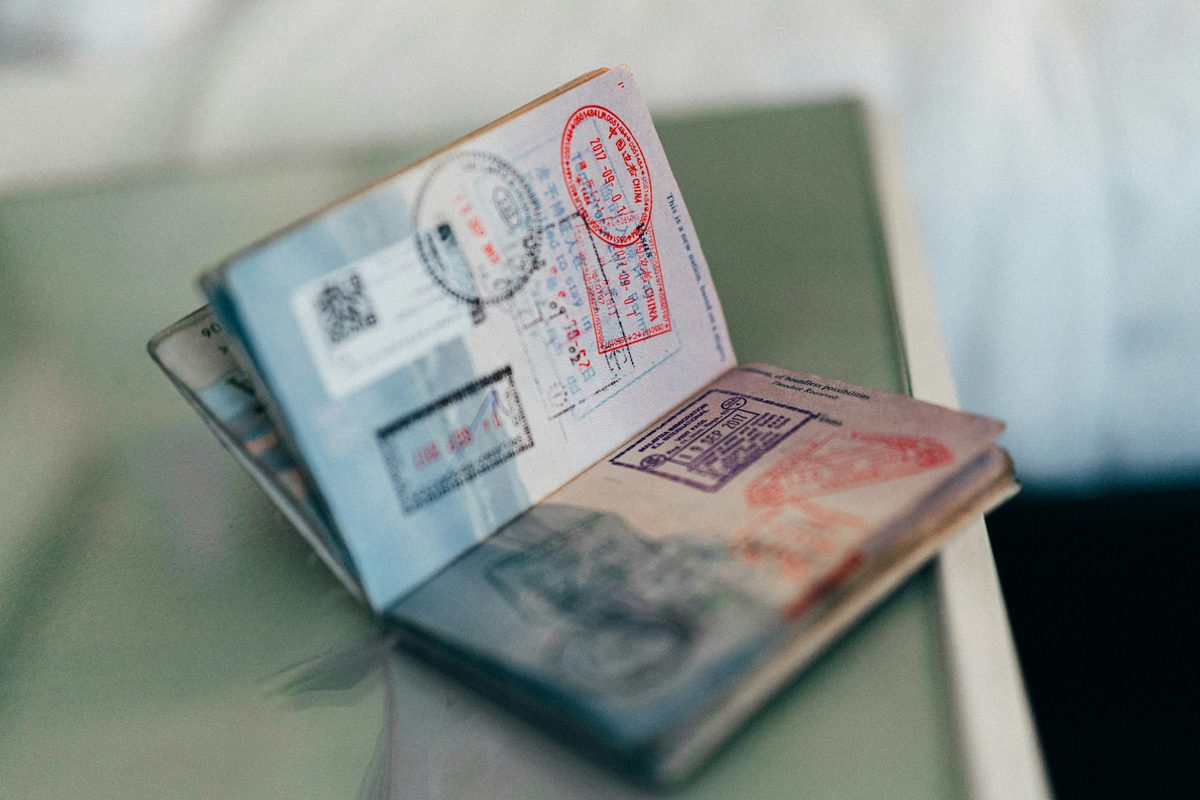 Turkish residence permit application documents — open passport with entry stamps